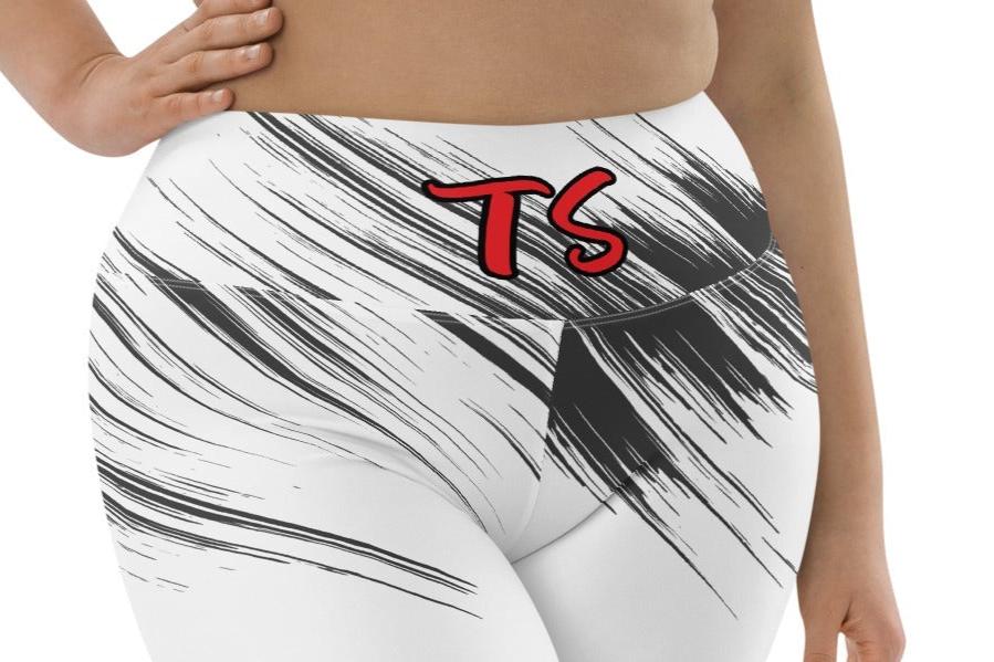 Lower front of woman wearing the black and white TrendSetter biker shorts with red and black 'TS' letters at waist