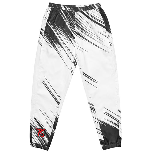 Front of black and white track pants with text saying 'TS' on bottom of right leg