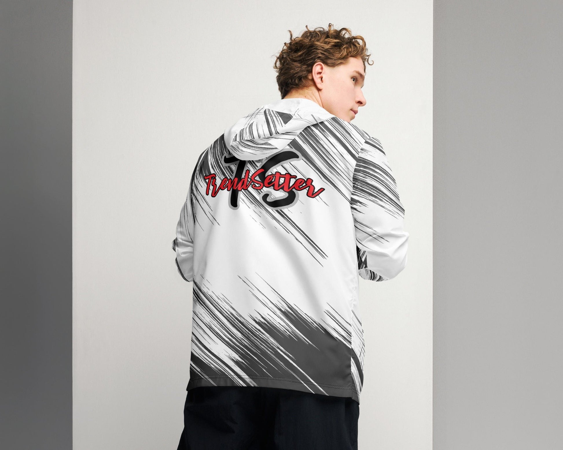 Back of a black and white windbreaker with red text saying 'TrendSetter' and black and grey text saying 'TS' 