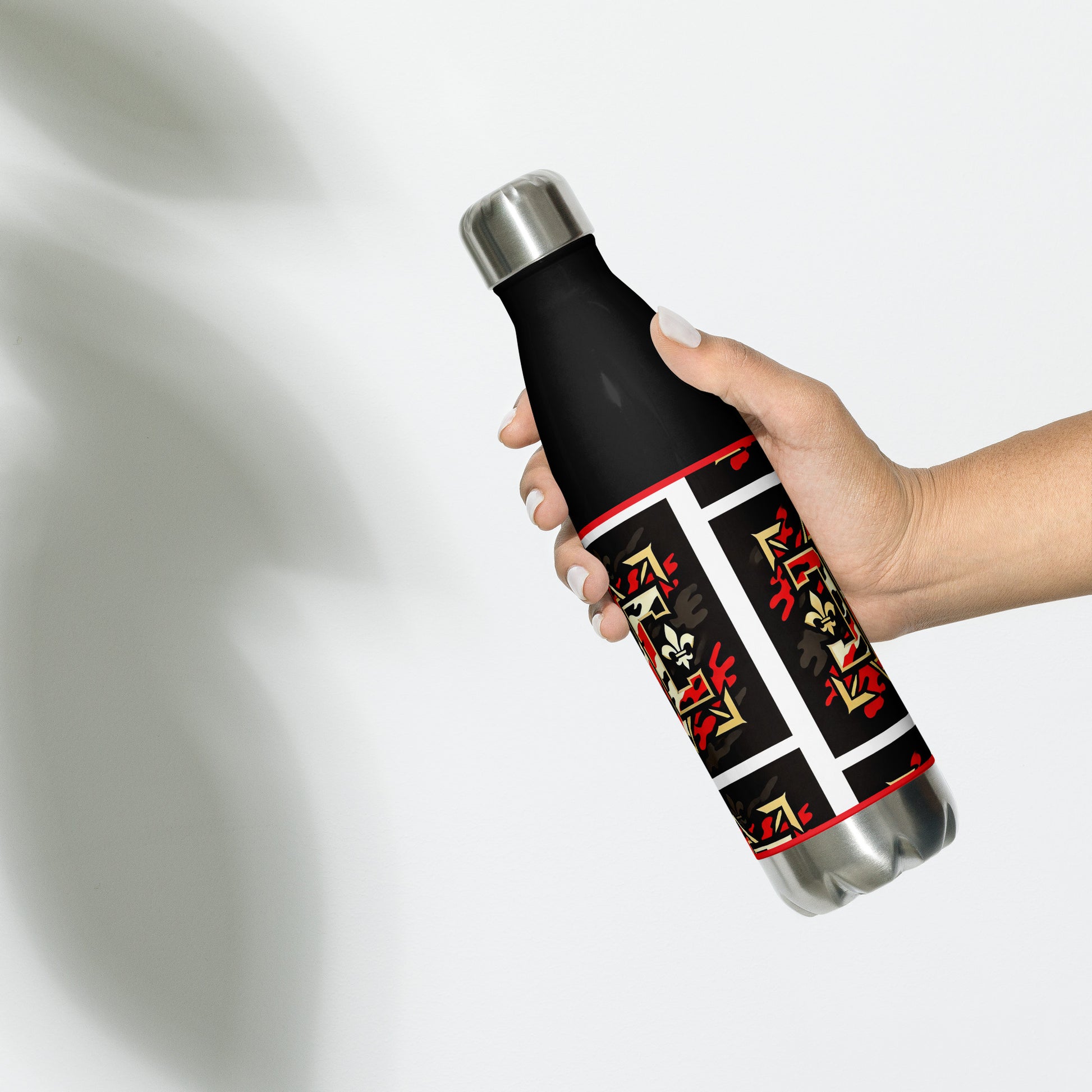 Backof black water bottle with gold red and white design with letters 'D' and 'C" as part of the design