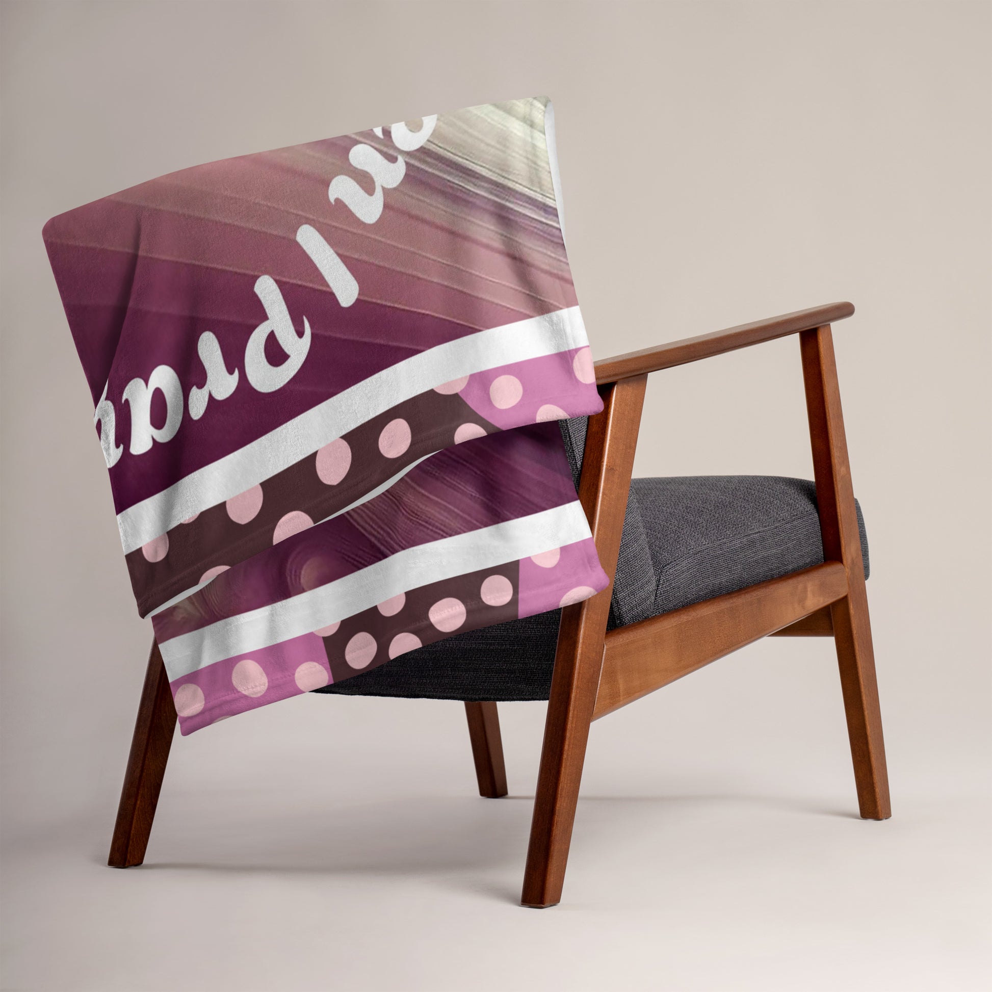Purplish 50 x 60 throw blanket folded and hung on back a chair