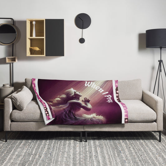 Purplish 50 x 60 throw blanket laying on a couch with image of woman praying heavenward and text saying 'when I pray'