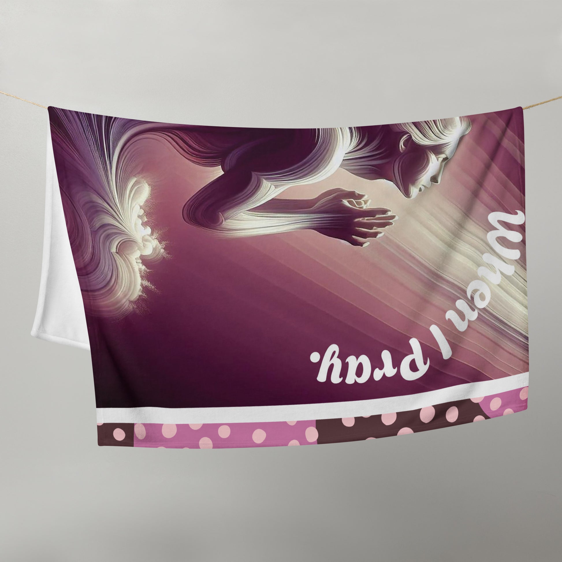 Purplish 50 x 60 throw blanket hung on back a clothesline with image of woman praying heavenward and text saying 'when I pray'
