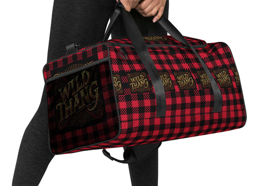 Right front of red and black duffle back with red, black and gold icon saying 'Wild Thang'