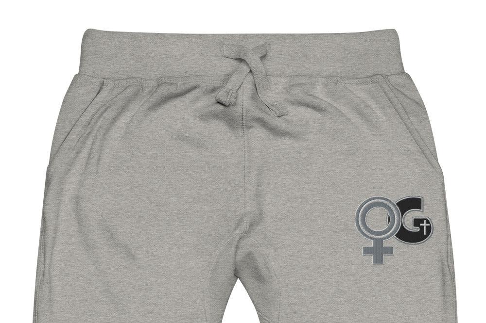 Front of grey sweatpants with embroidered symbol for woman of God on front, left thigh