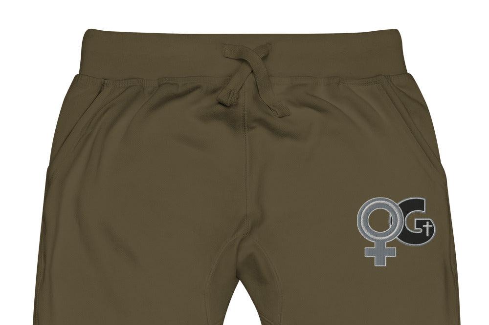 Front of military green sweatpants with embroidered symbol for woman of God on front, left thigh