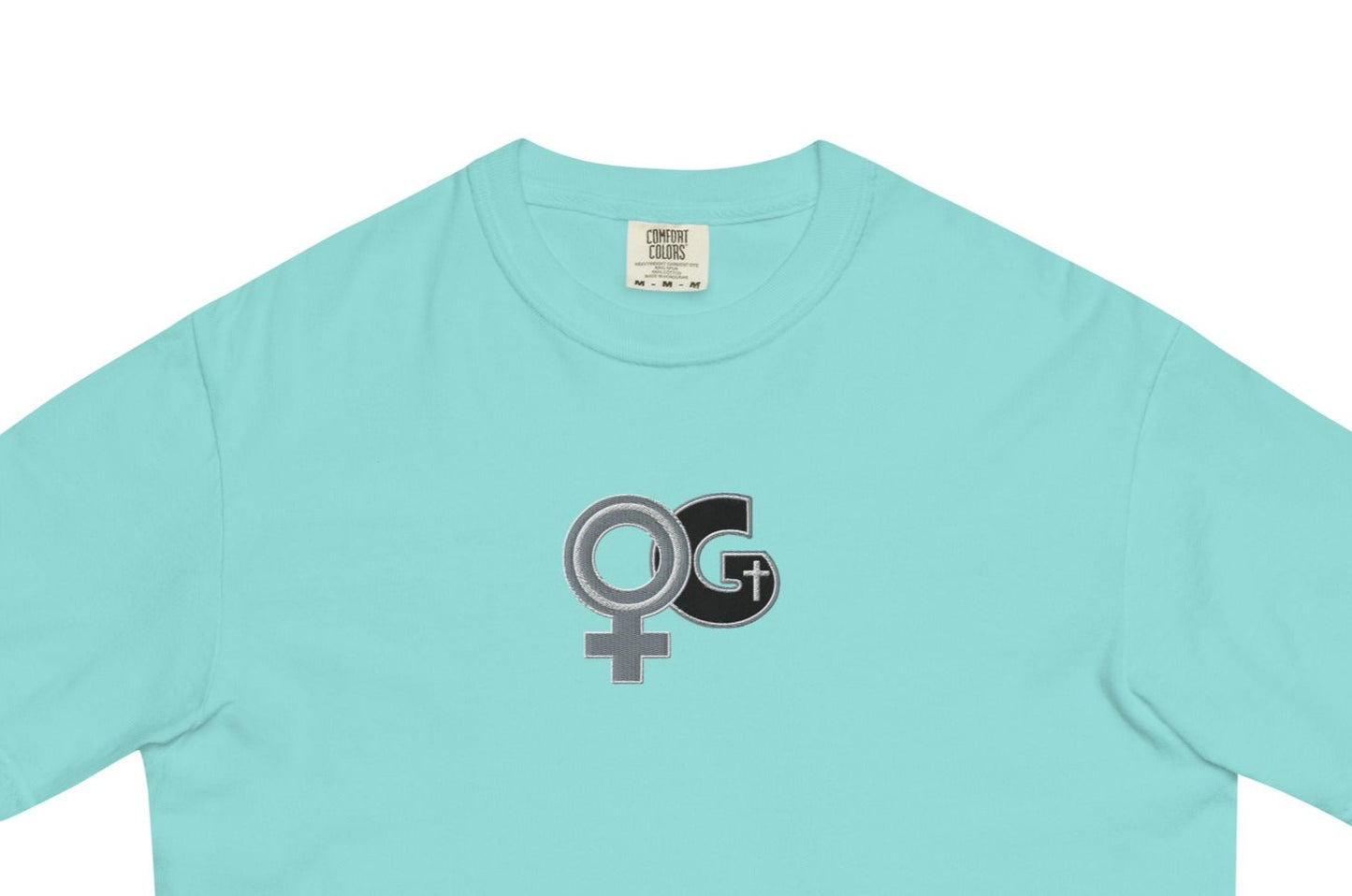 Front of lagoon blue t-shirt with embroidered black and grey Woman of God symbol