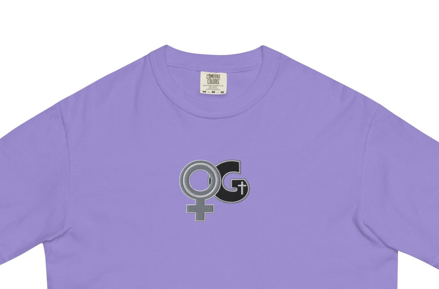 Front of violet t-shirt with embroidered black and grey Woman of God symbol