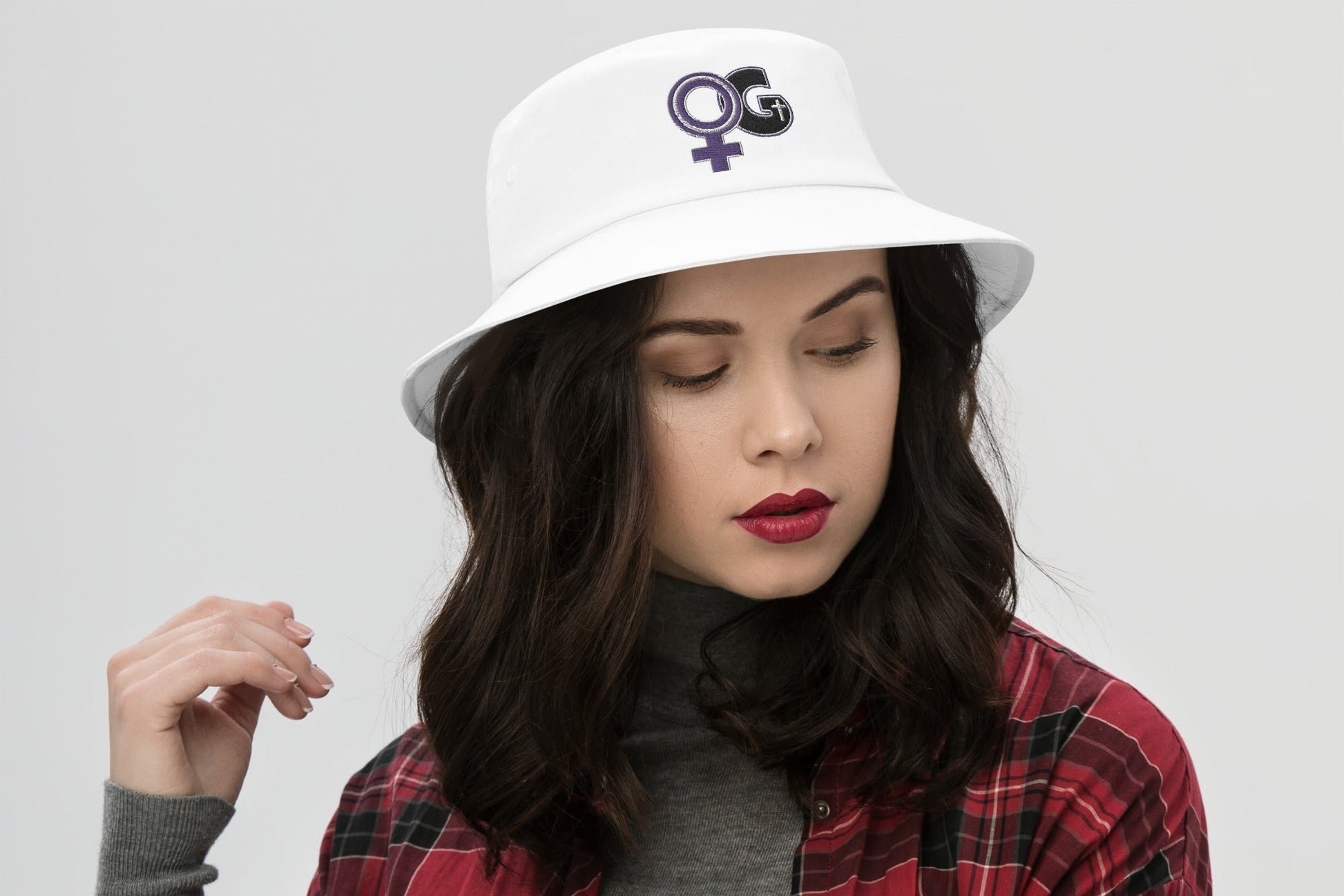 Front of white bucket hat with purple and black Woman of God image