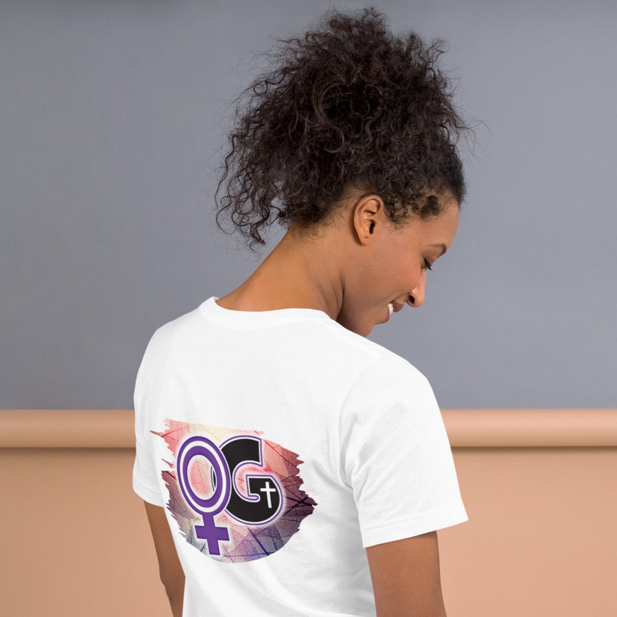 Back of white t-shirt with purple, pink, and black Woman of God symbol