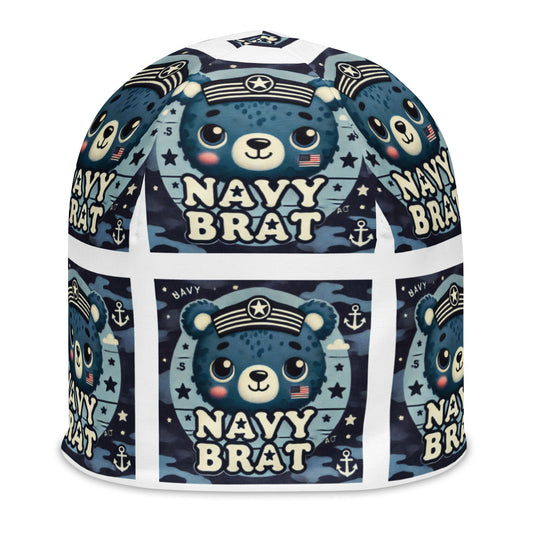 Front of youth beanie with blue baby bear and words saying 'navy brat' in blue pattern