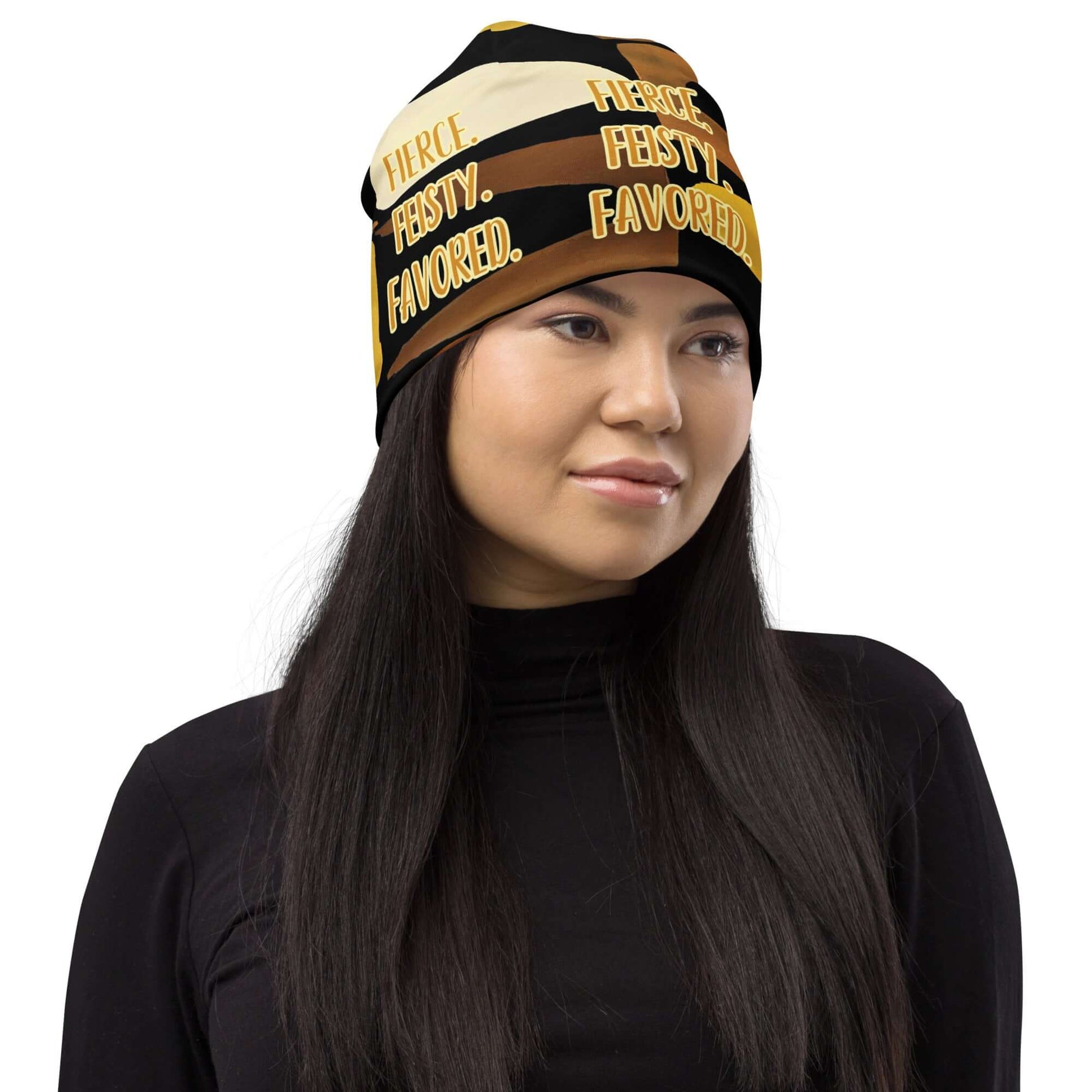 Product mockupHead shot of woman wearing the Fierce. Feisty. Favored. black, brown, beige and gold print beanie, front right-side view