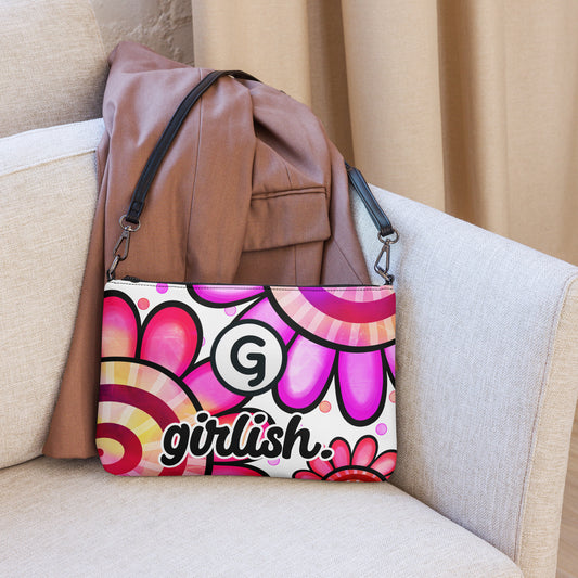 Front of crossbody bag with purple and pink daisy print and G logo and 'girlish' text
