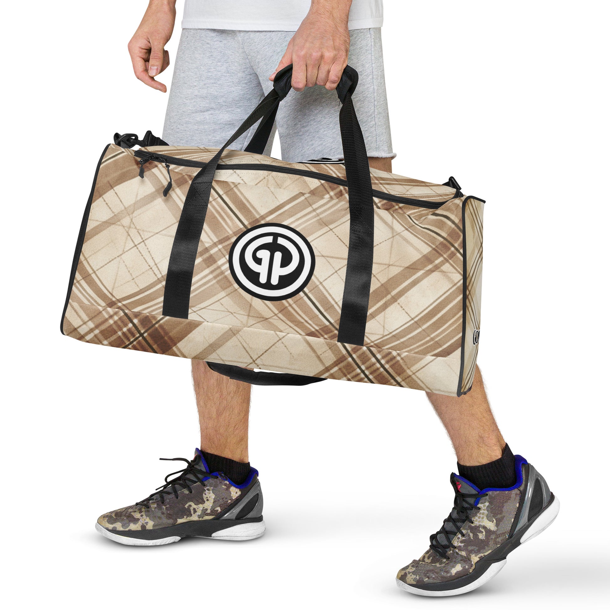 Front of brittle colored plaid background duffel with 'GP' logo being carried by man