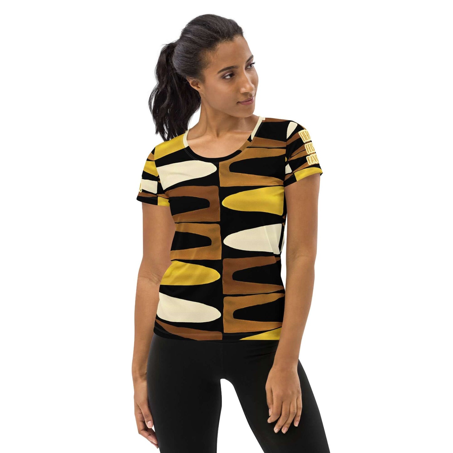 Half body front view of a woman wearing the Fierce. Feisty. Favored. black, brown, beige and gold print short sleeved t-shirt