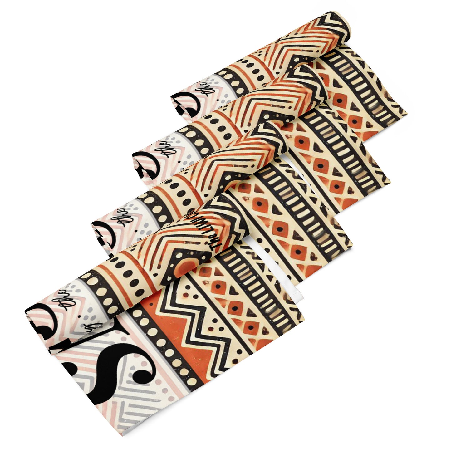 Front of 4 rolled LIWI cloths with orange, beige, black and white pattern